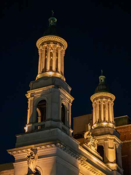 Night view of lit church columns and pillars at Saint John Baptiste in NYC