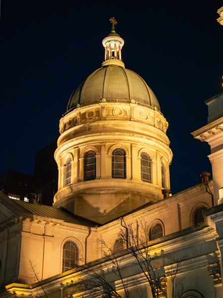 Night view of lit church dome at Saint John Baptiste in NYC